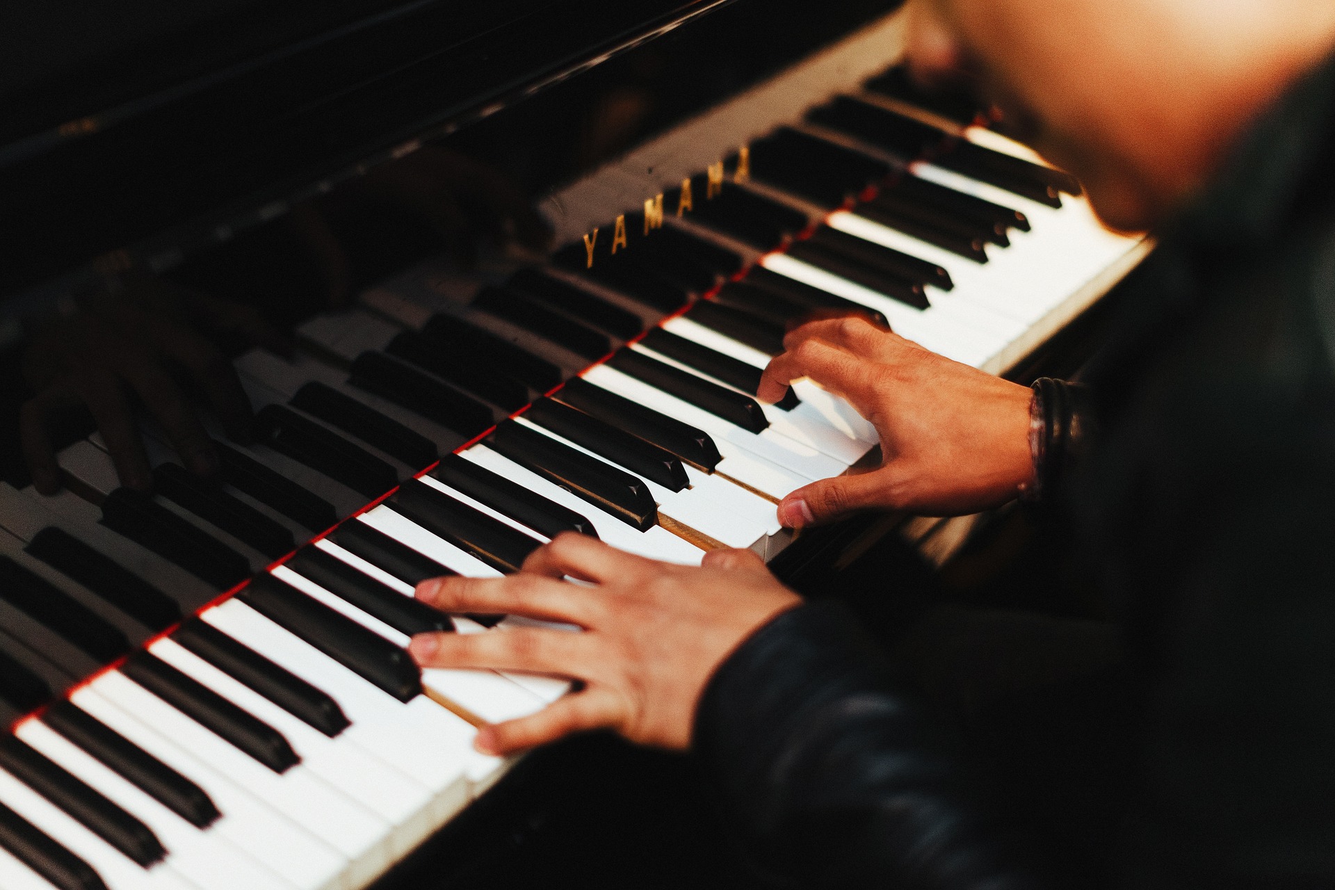A close up of a person playing a piano
