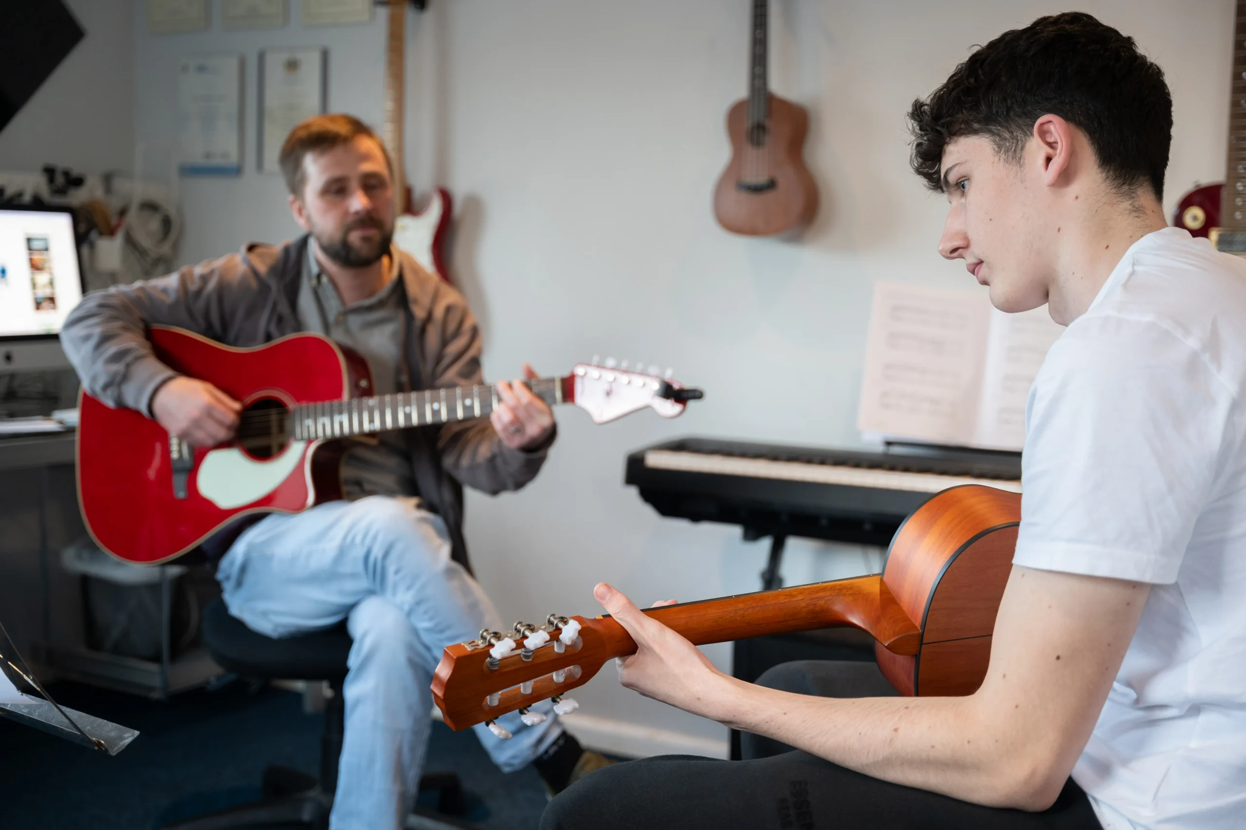 Two people playing guitars